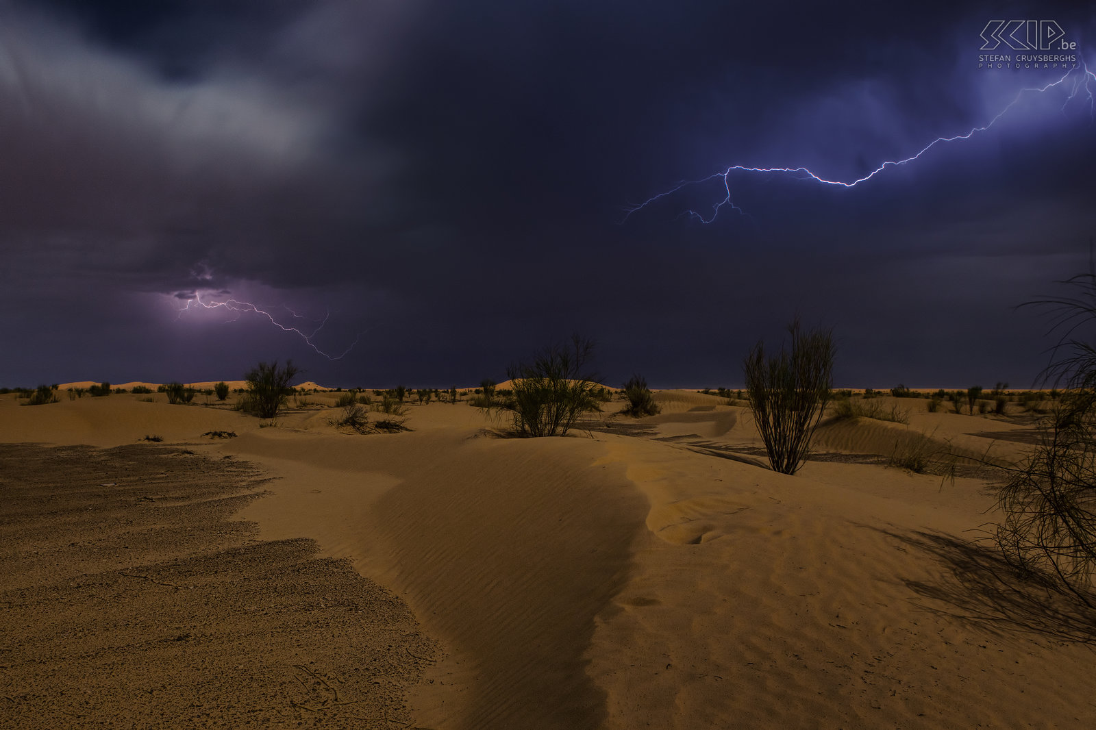 Lightning in the desert During our 5 day hike in the Grand Erg Oriental we always slept under the starry sky. Our first night was memorable because it was full moon with a cloudy sky, some rain showers and a lot of thunder and lightning. When the rain stopped I woke up to try to make some photos of the lightning. I made several photos but this is definitely my best photo, quite unique shot I think. Stefan Cruysberghs